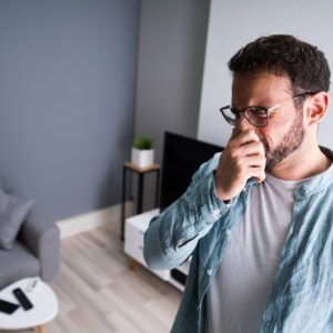 man covering his nose